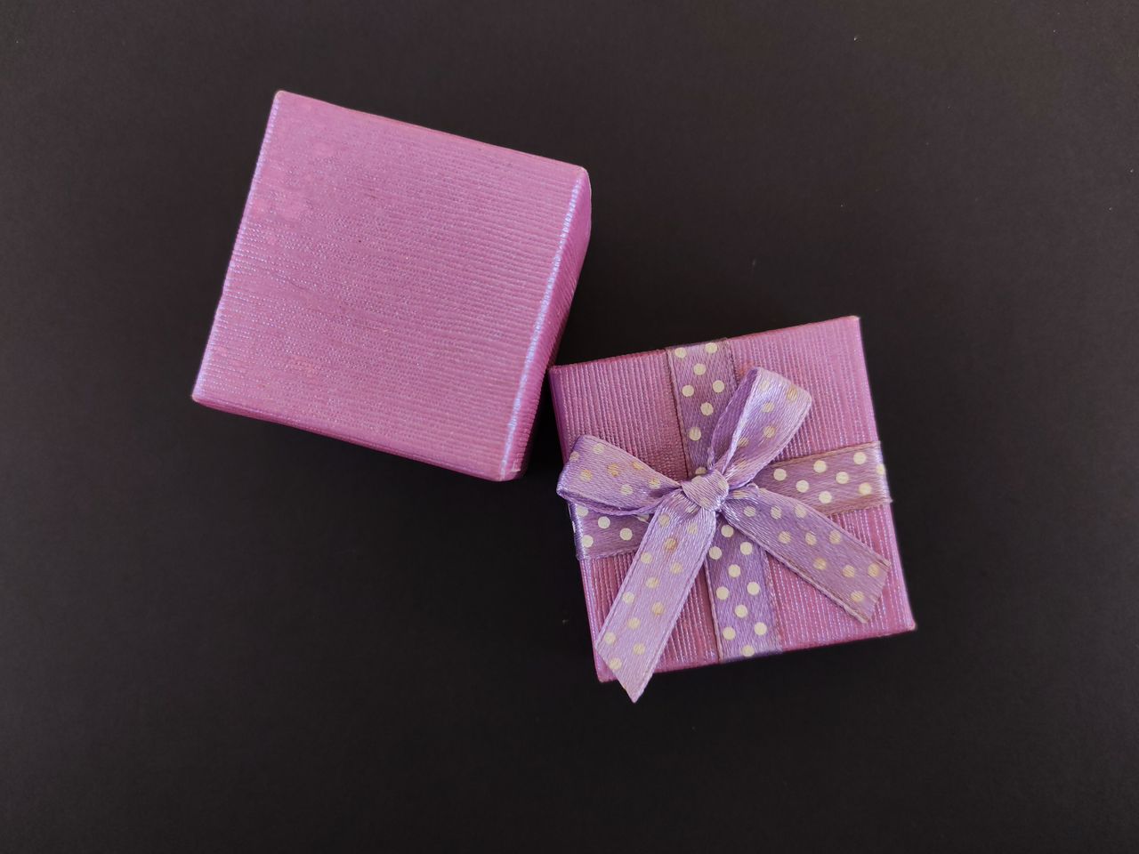Elegant purple gift box with polka dot ribbon, perfect for celebrations.